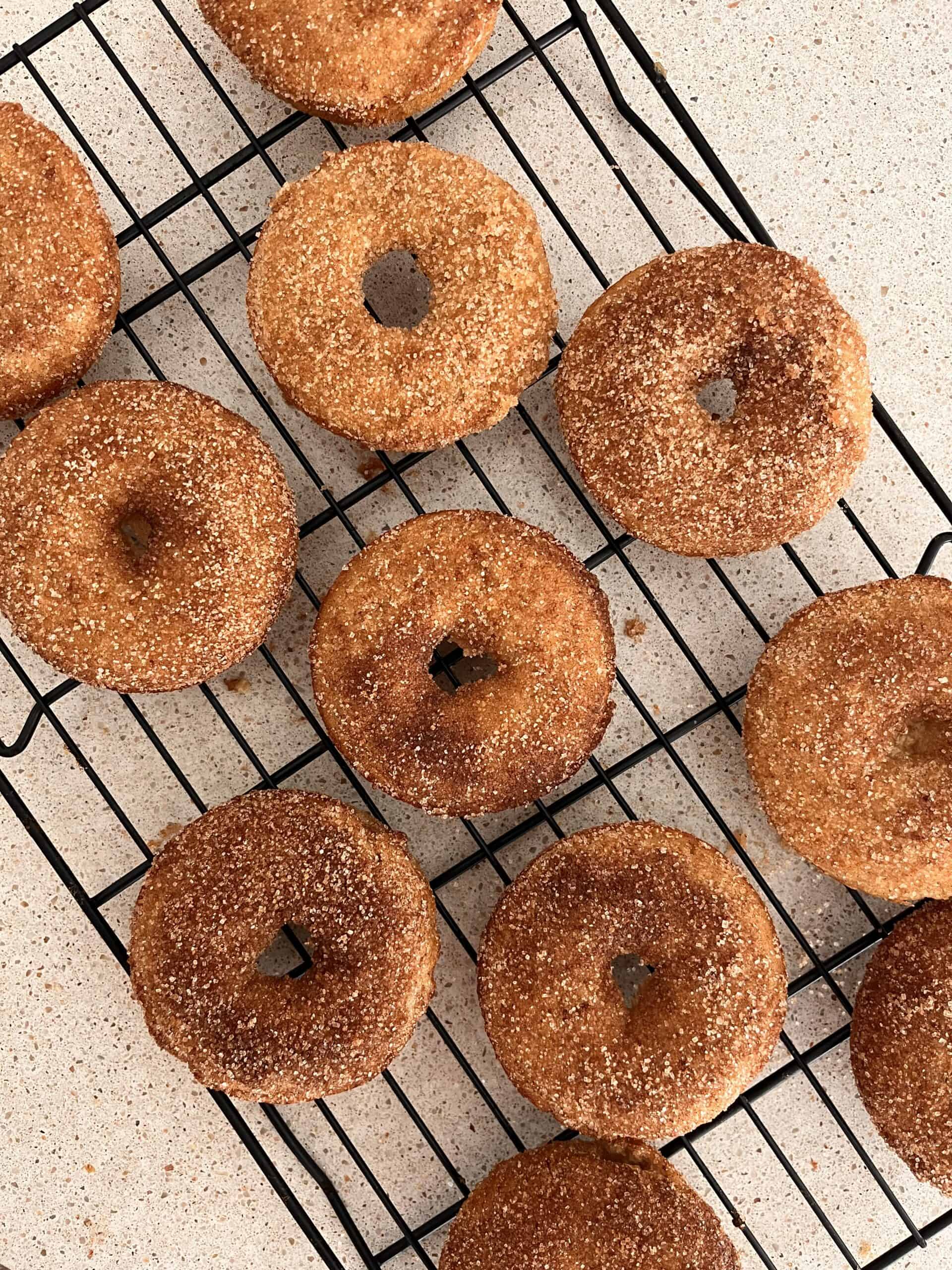baked apple cider donuts on a cooling rack