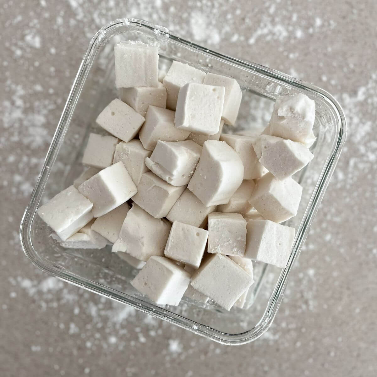 gut-friendly marshmallows cut up and stacked on top of each other in a clear square container