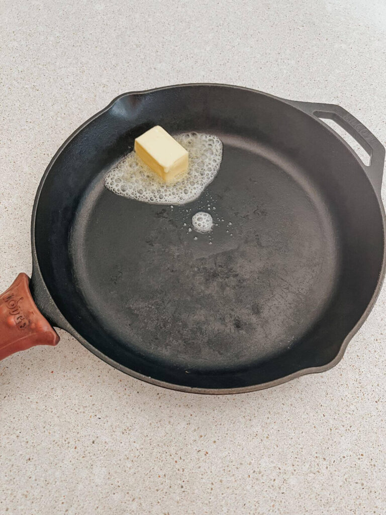 butter melting in a cast-iron pan 