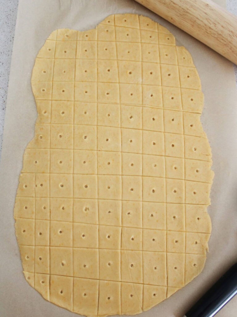cheese crackers cut and holes placed in the middle of each. ready to bake. 