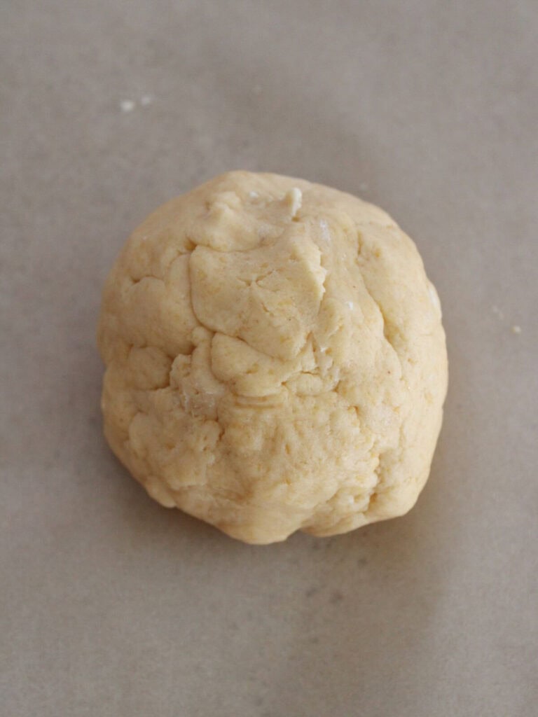 a ball of cheese cracker dough ready to be wrapped and chilled. 