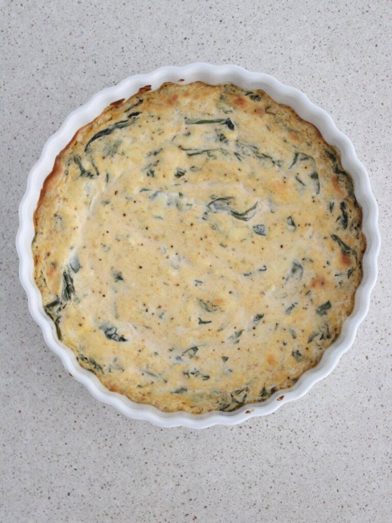 spinach dip baked in glass dish ready to serve. 